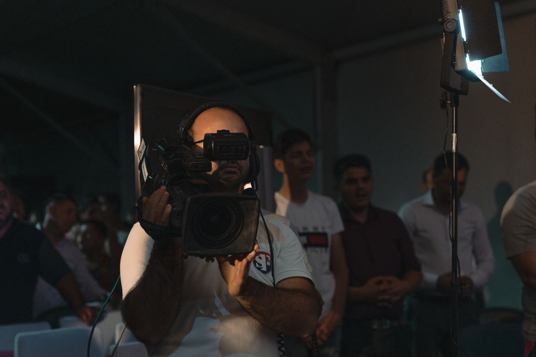 A camera operator filming a church gathering
