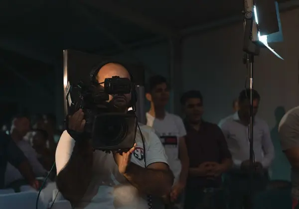 A camera operator filming a church gathering