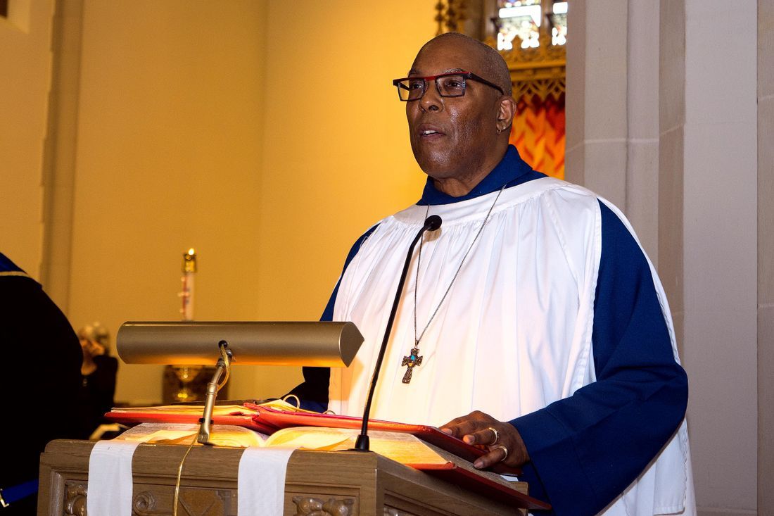A pastor preaching from a lectern in church