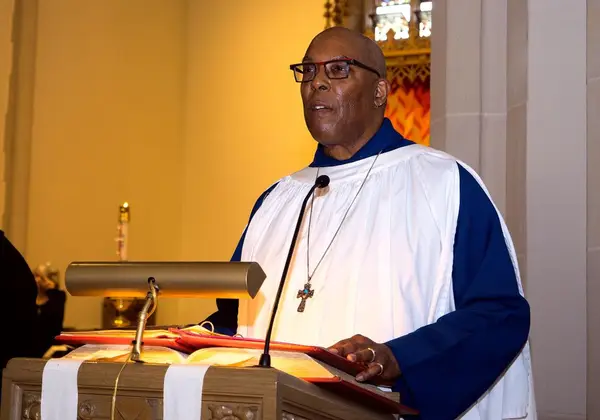 A pastor preaching from a lectern in church