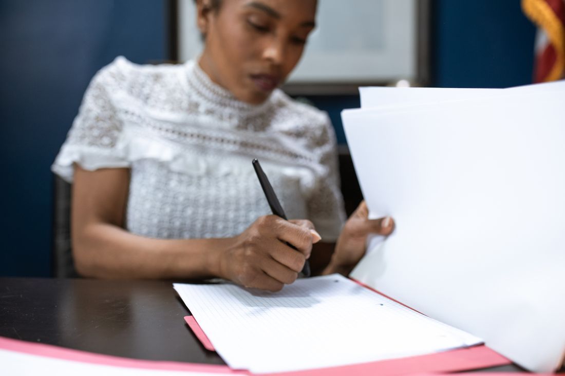 A church administrator working through paperwork at a desk