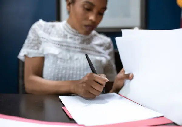 A church administrator working through paperwork at a desk
