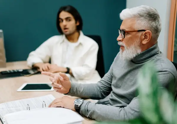 An experienced leader speaking with a younger colleague