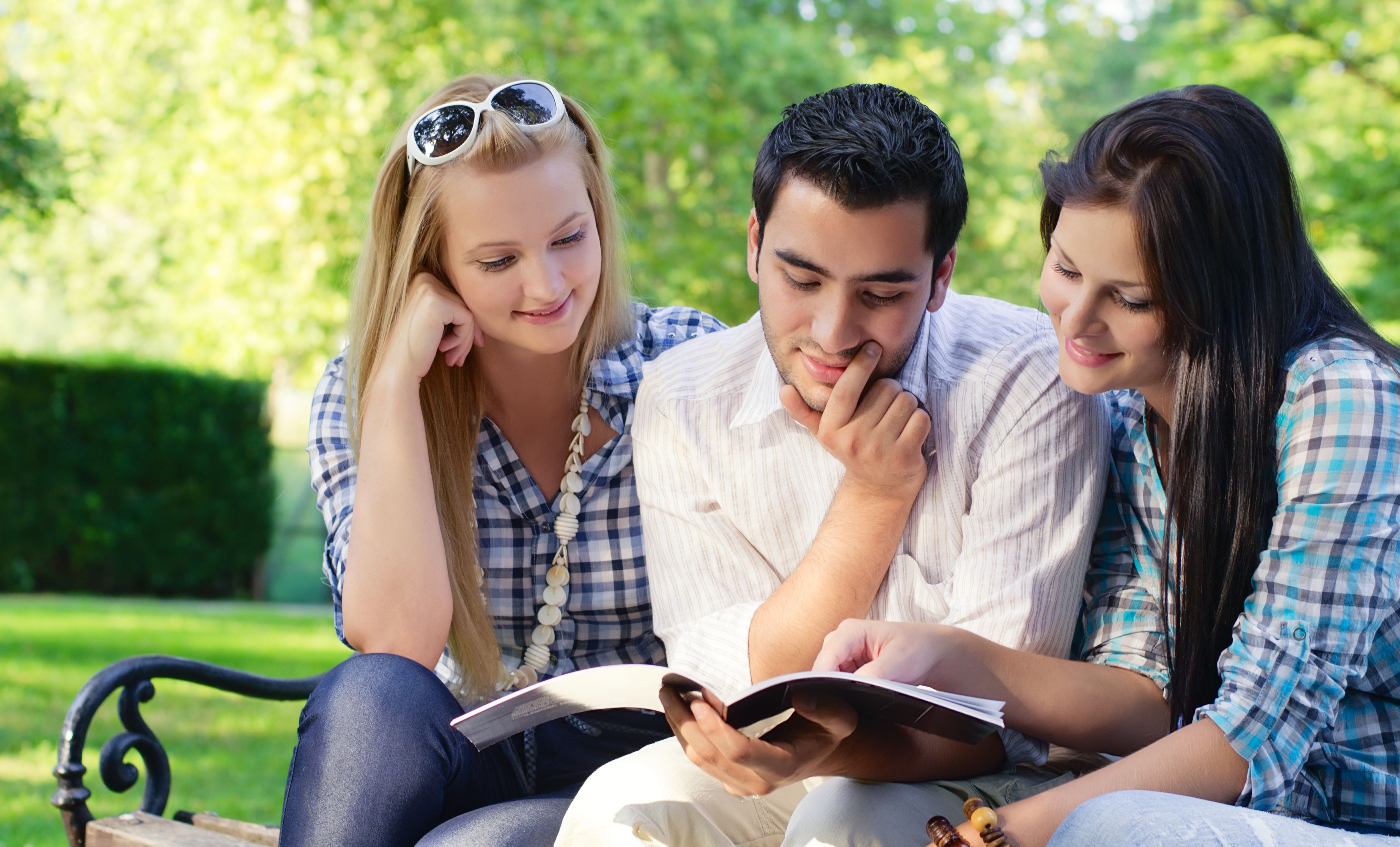 Friends sitting close together in warm sunlight, fully present to one another — a glimpse of the honor and regard every heart longs to give and to receive.