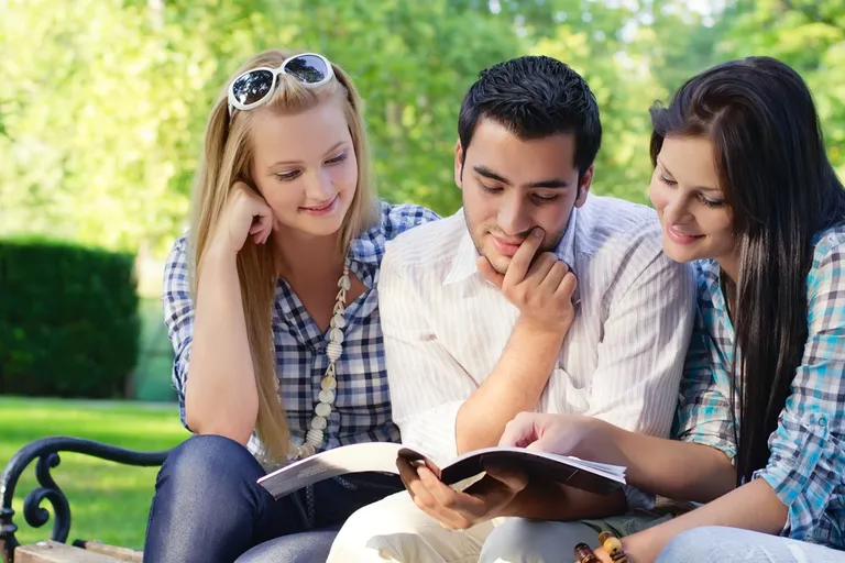 Friends sitting close together in warm sunlight, fully present to one another — a glimpse of the honor and regard every heart longs to give and to receive.