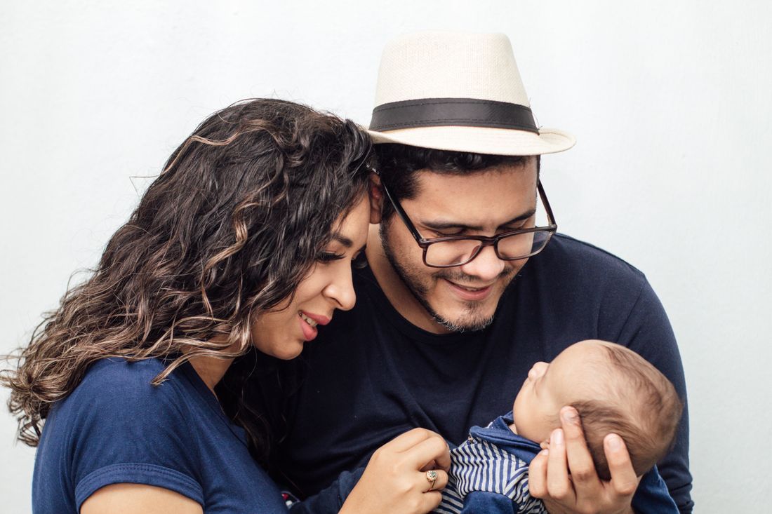 A couple gazing tenderly at their newborn