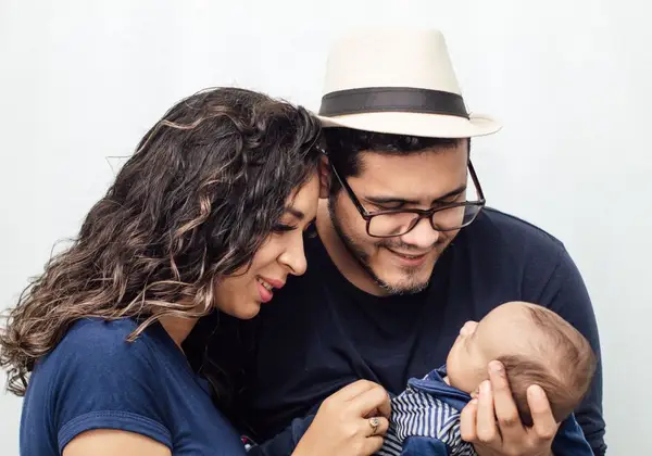 A couple gazing tenderly at their newborn