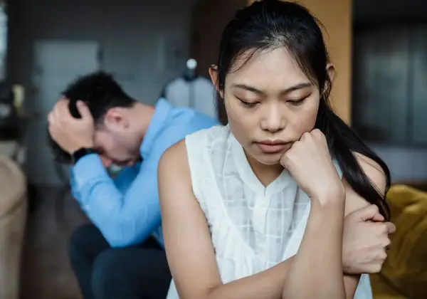 A husband and wife sitting in the strain of an unresolved moment