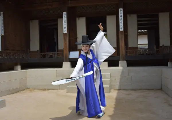 A Korean woman dancing in hanbok