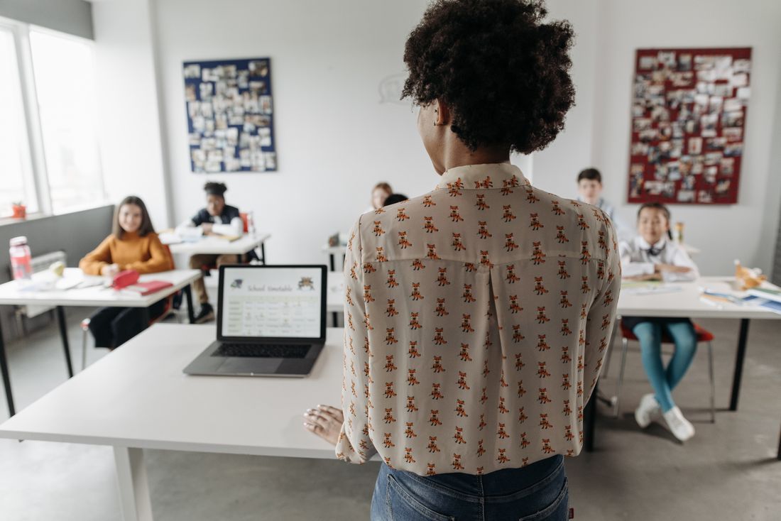 A teacher standing before her class at the start of another day
