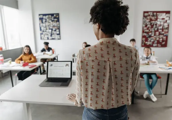 A teacher standing before her class at the start of another day