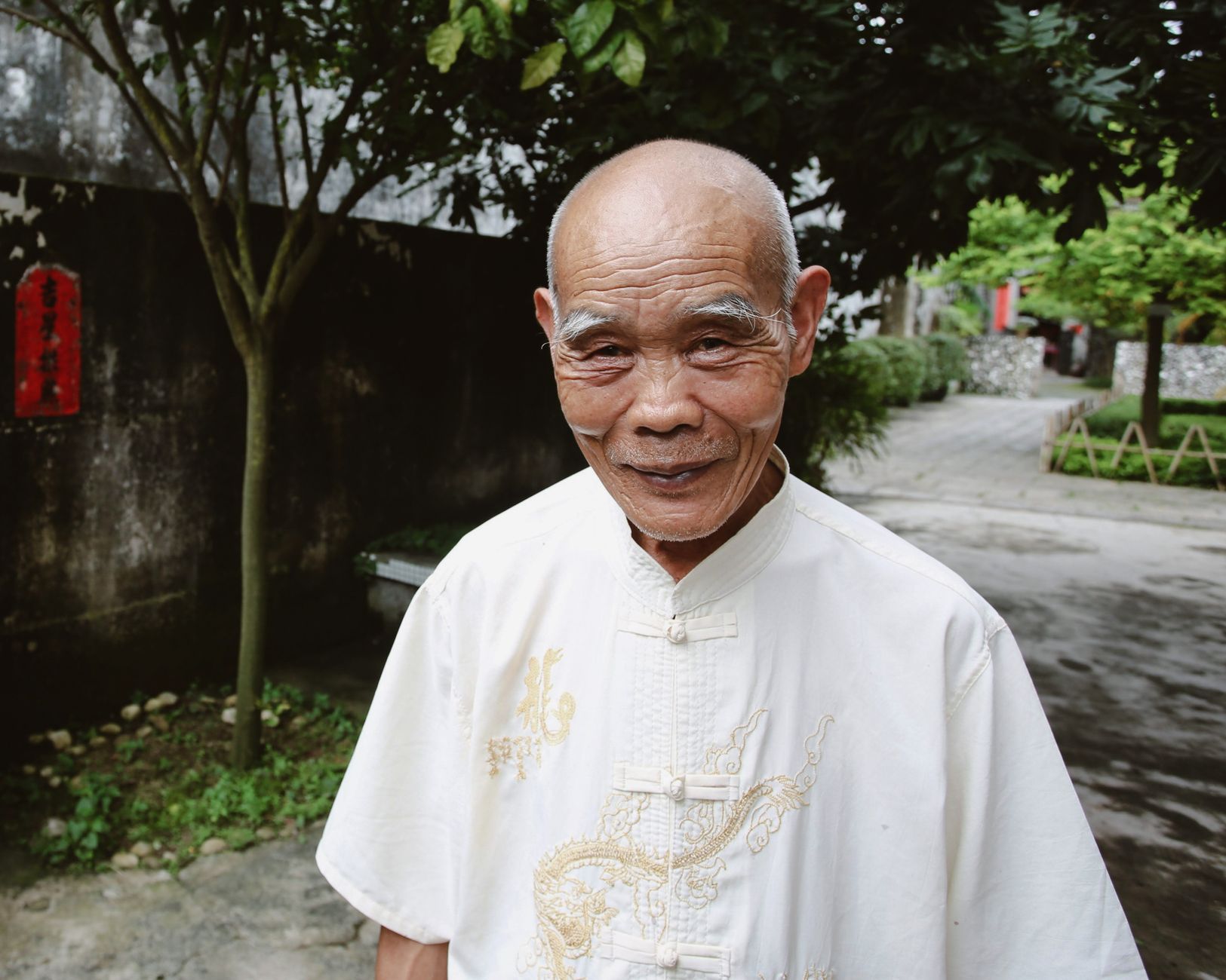 A smiling elderly Chinese man