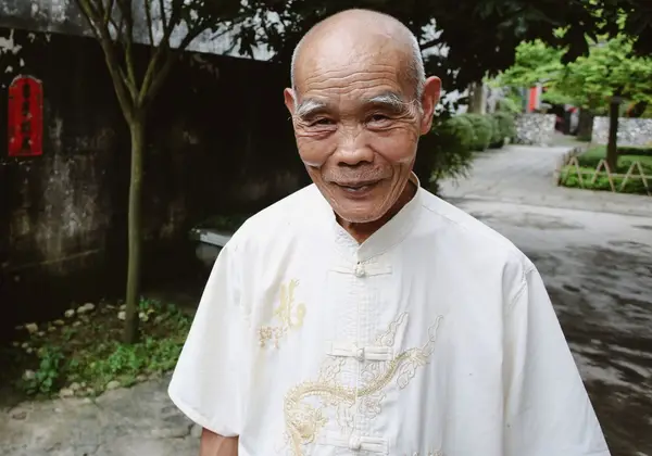 A smiling elderly Chinese man