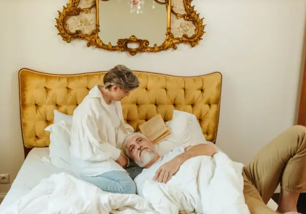 A woman caring for her resting husband at home