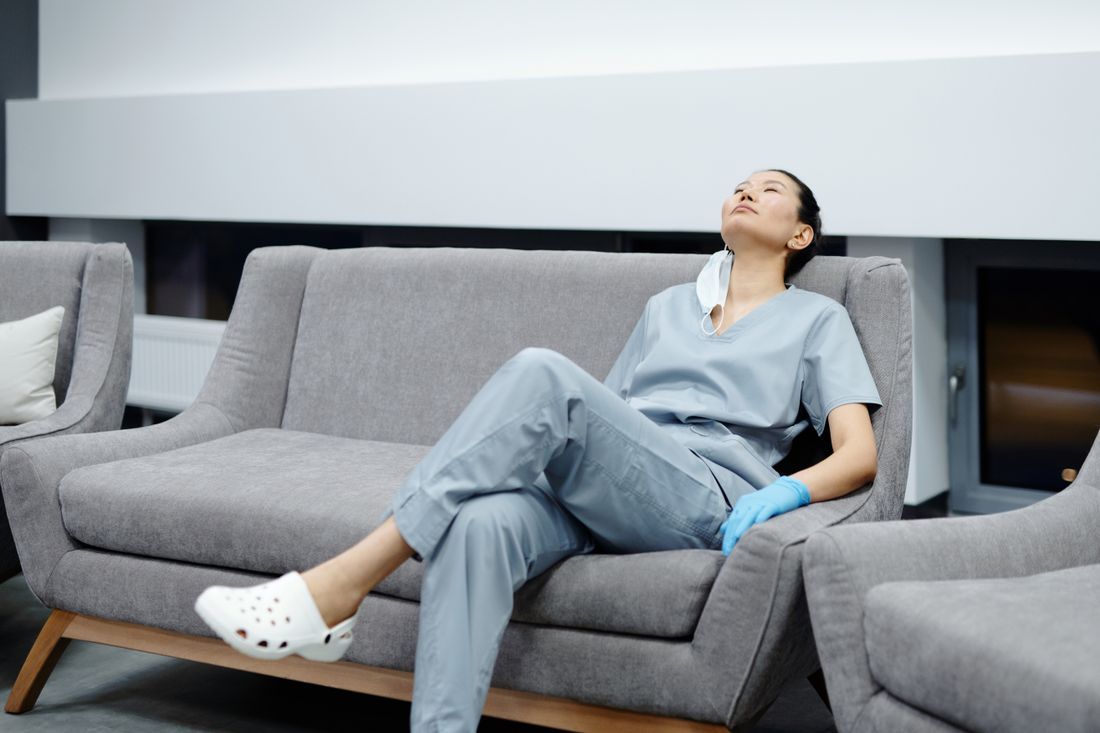 A nurse in surgical gown pausing between procedures