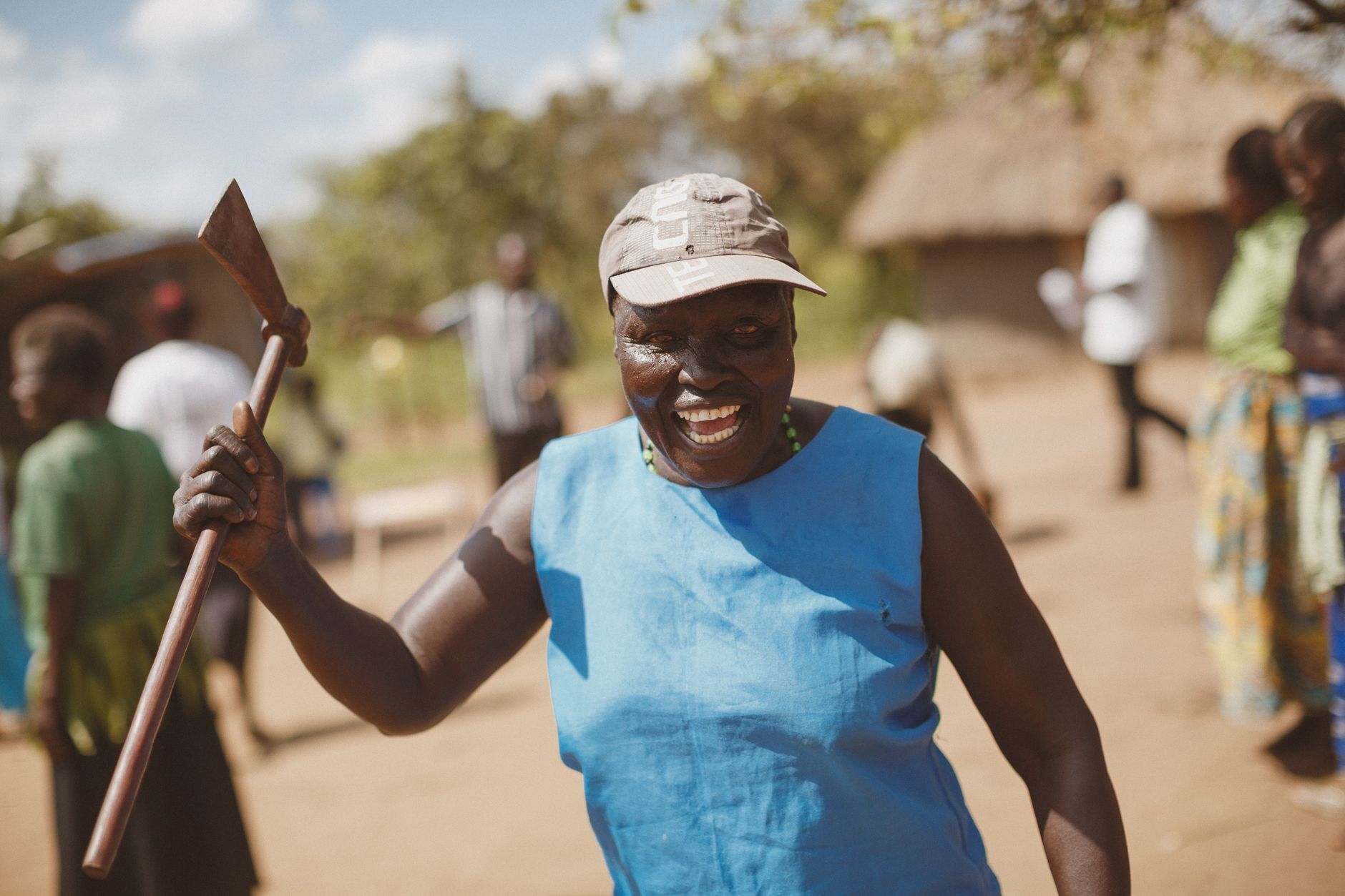 A smiling Ugandan woman in a village