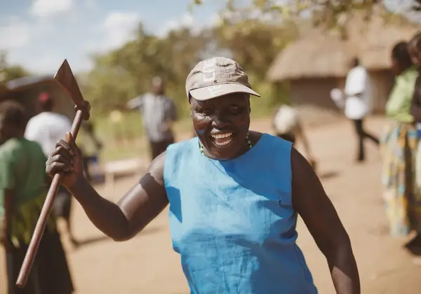 A smiling Ugandan woman in a village