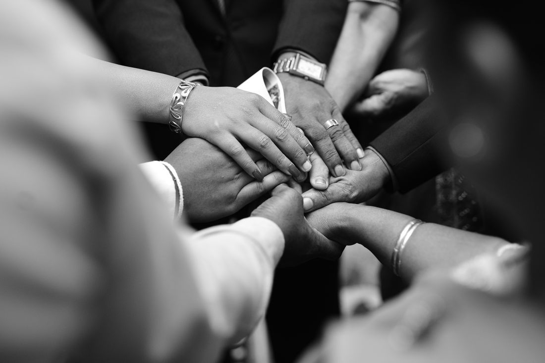 Hands joined together in a circle of support