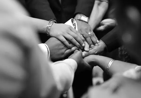 Hands joined together in a circle of support