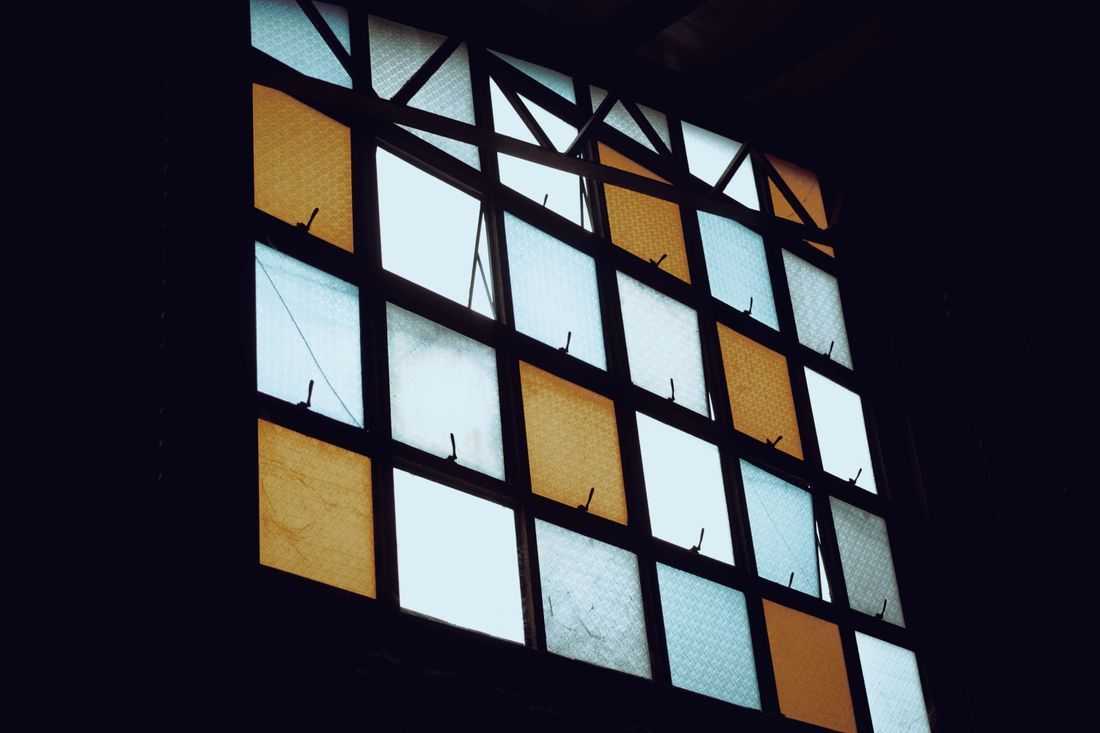 Light coming through a grid of frosted window panes