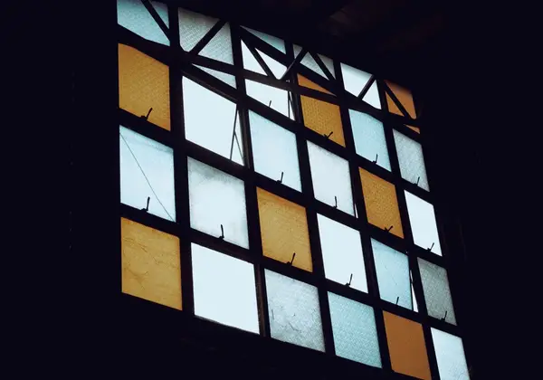Light coming through a grid of frosted window panes