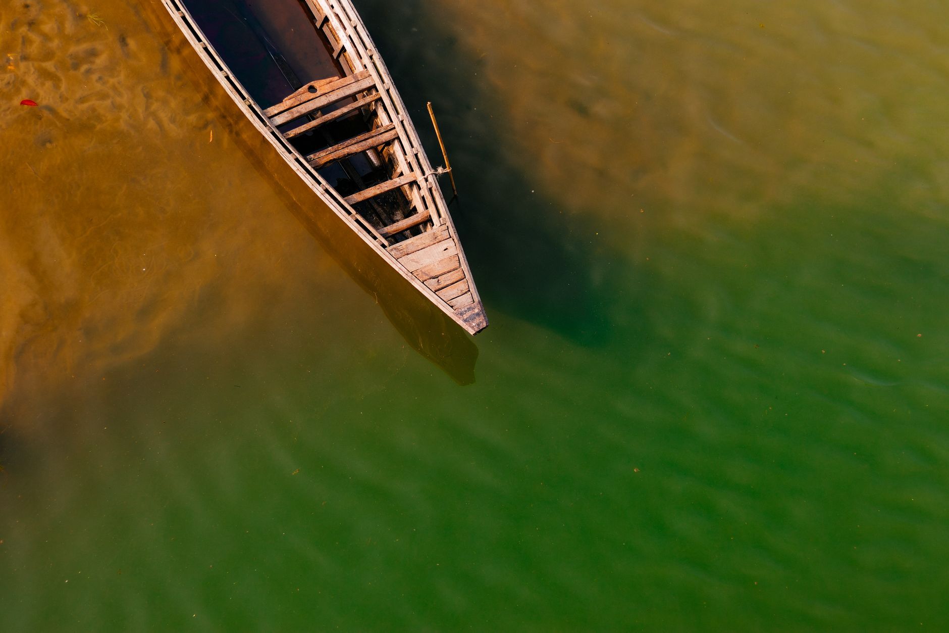 A wooden country boat on a river in Bangladesh