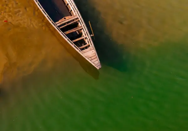 A wooden country boat on a river in Bangladesh