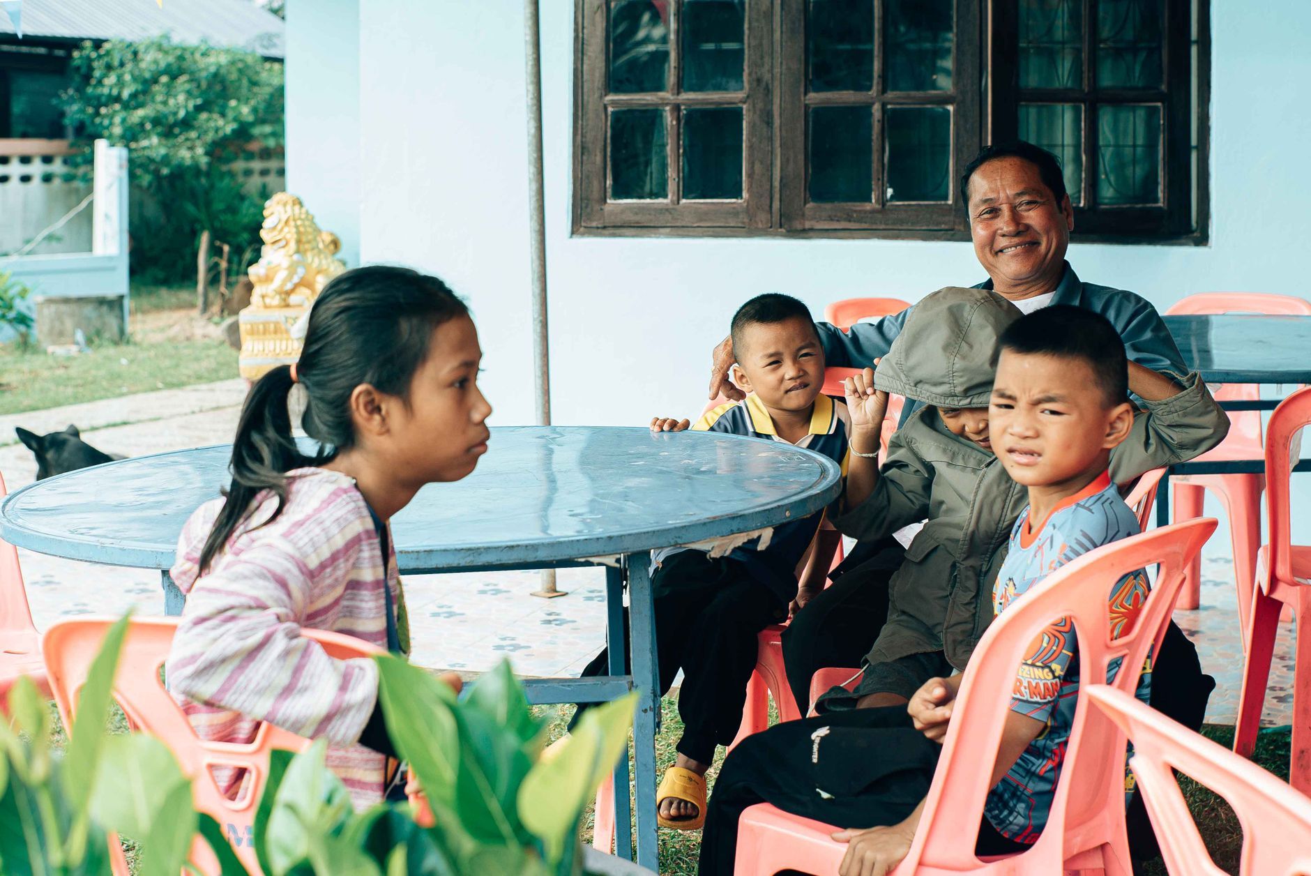 A Thai grandfather and children gathered together