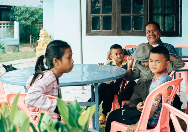A Thai grandfather and children gathered together
