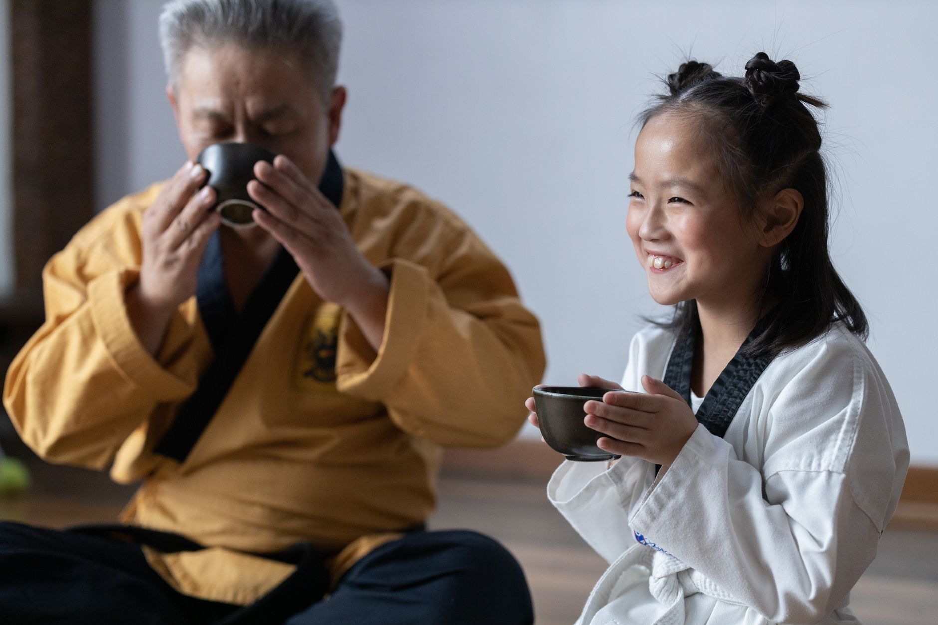 A Korean elder sharing tea with a young girl