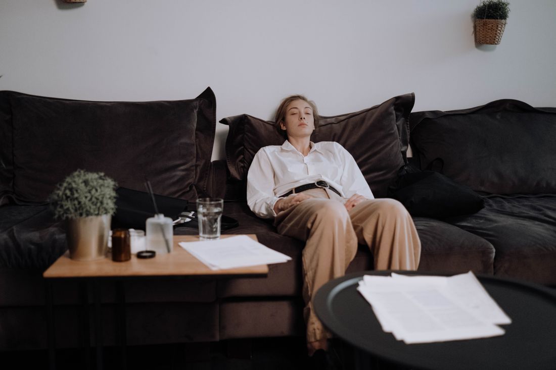A weary woman resting with her eyes closed amid the day's demands