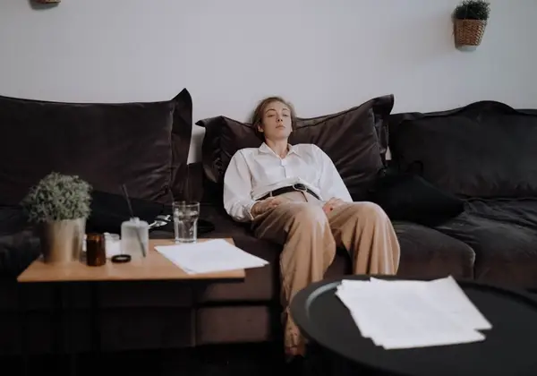 A weary woman resting with her eyes closed amid the day's demands