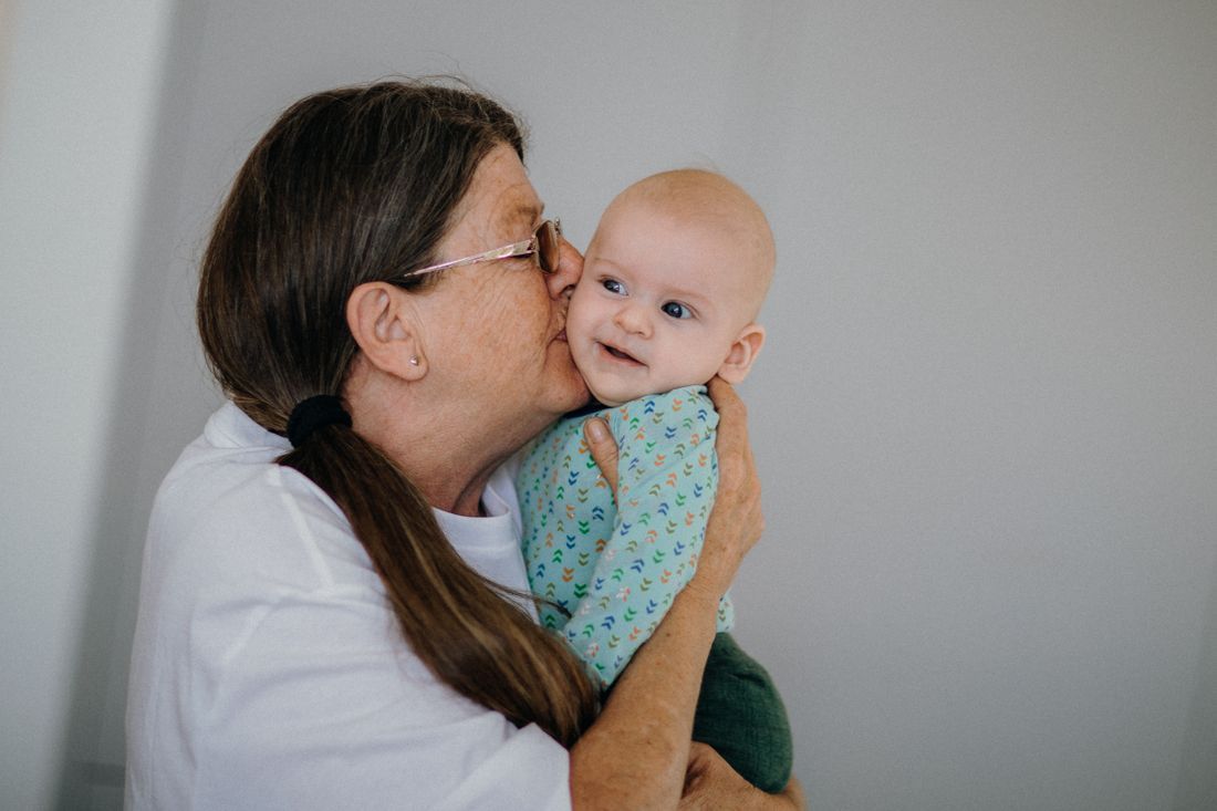 A nursery volunteer tenderly holding a baby