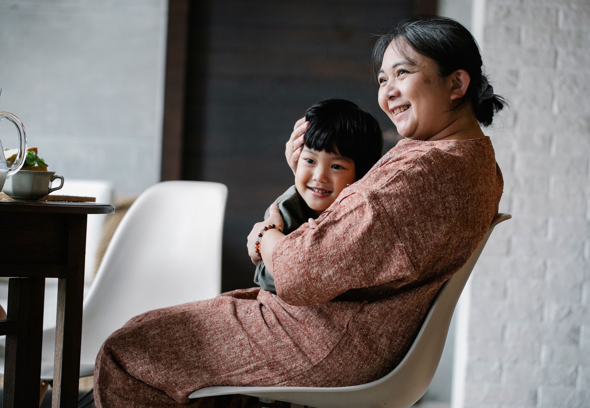 A grandmother embracing her grandchild