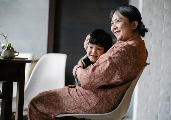 A grandmother embracing her grandchild