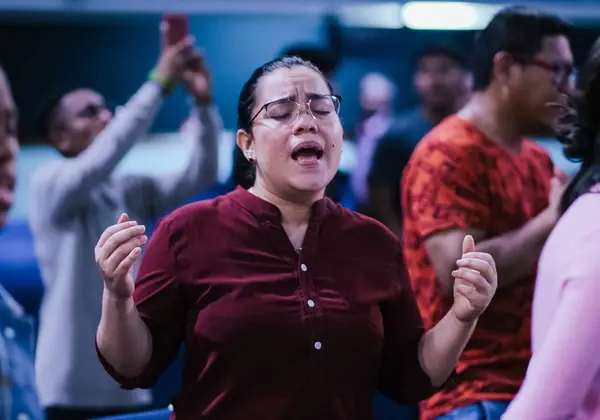 A woman worshipping with her hands lifted during a service