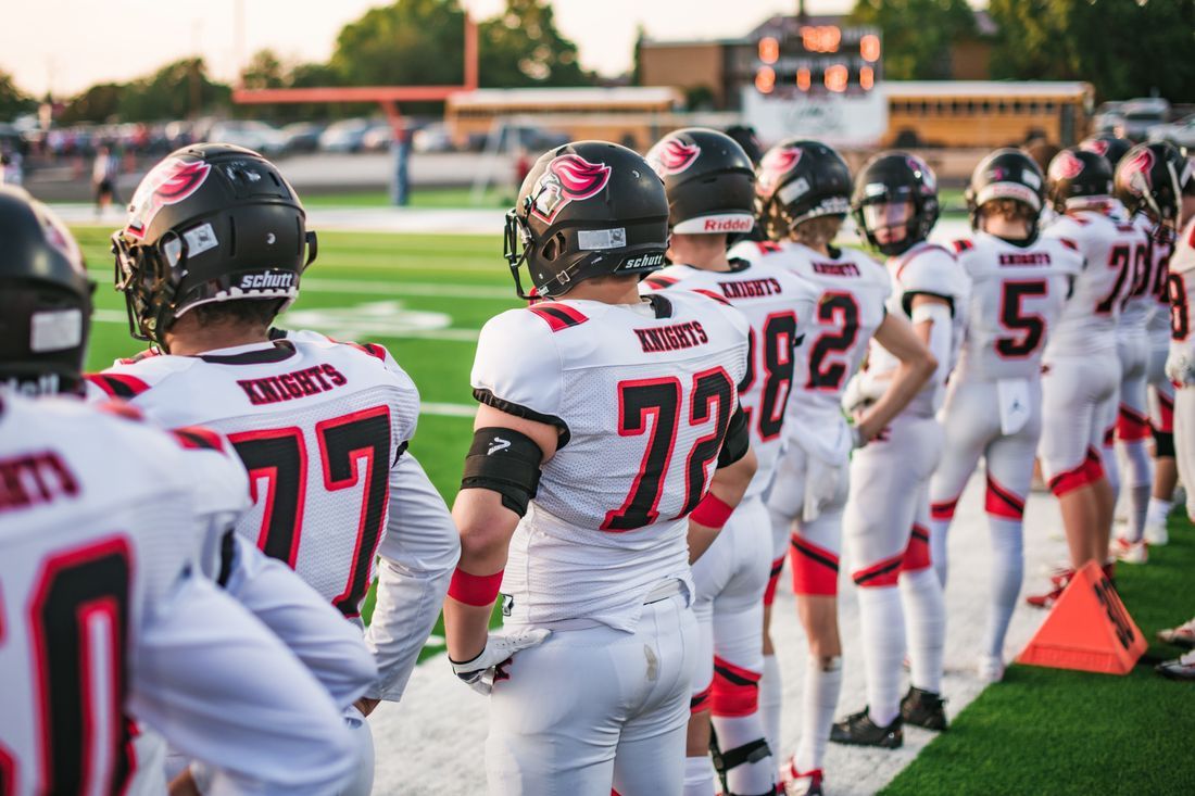 A football team lined up on the sideline before the game