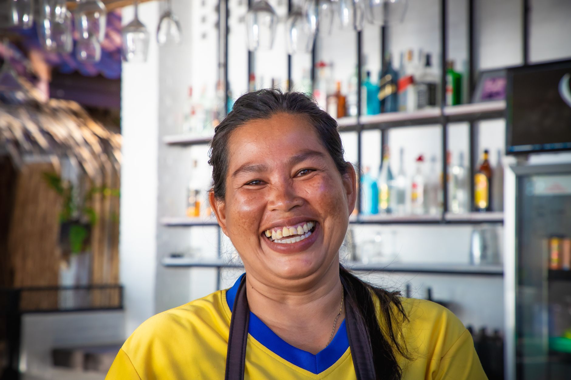 A Thai woman laughing brightly