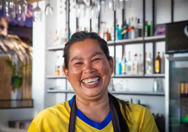 A Thai woman laughing brightly