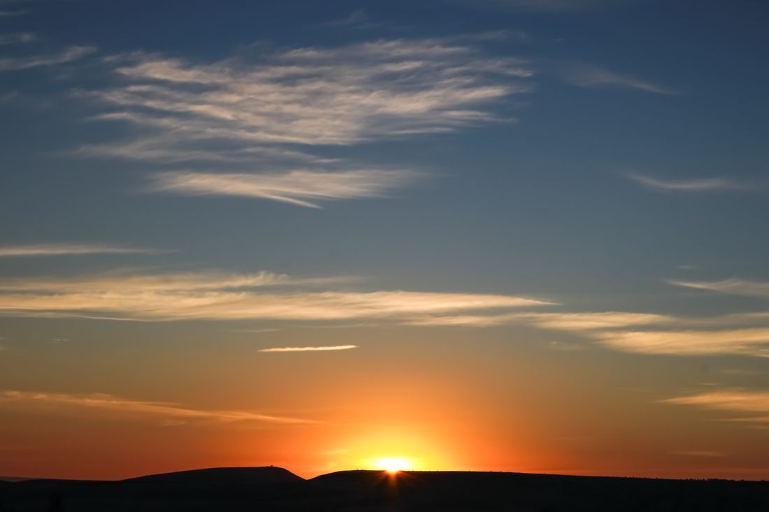 The sun rising over the hills on a new day