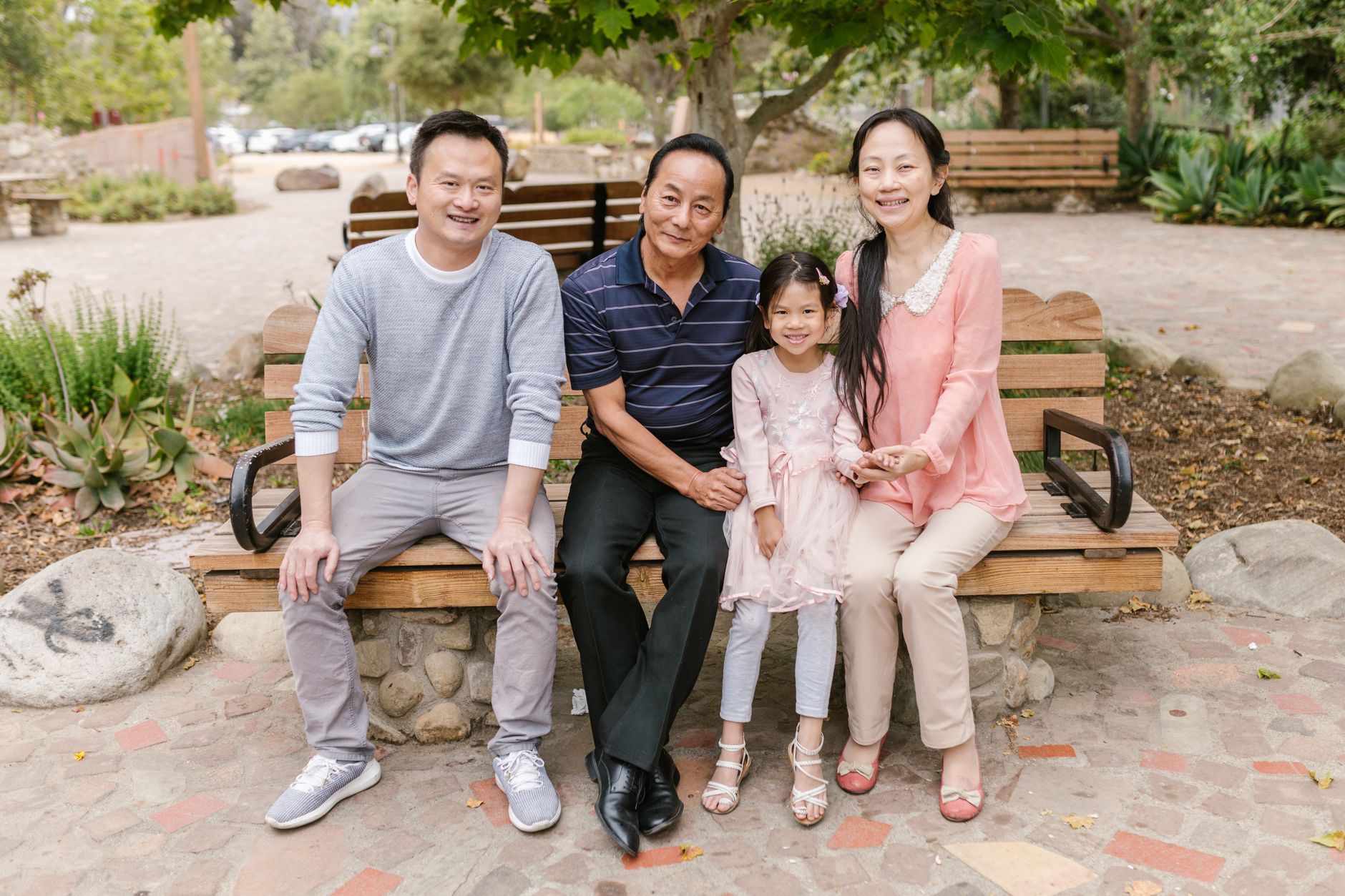 A joyful Hong Kong family on a park bench
