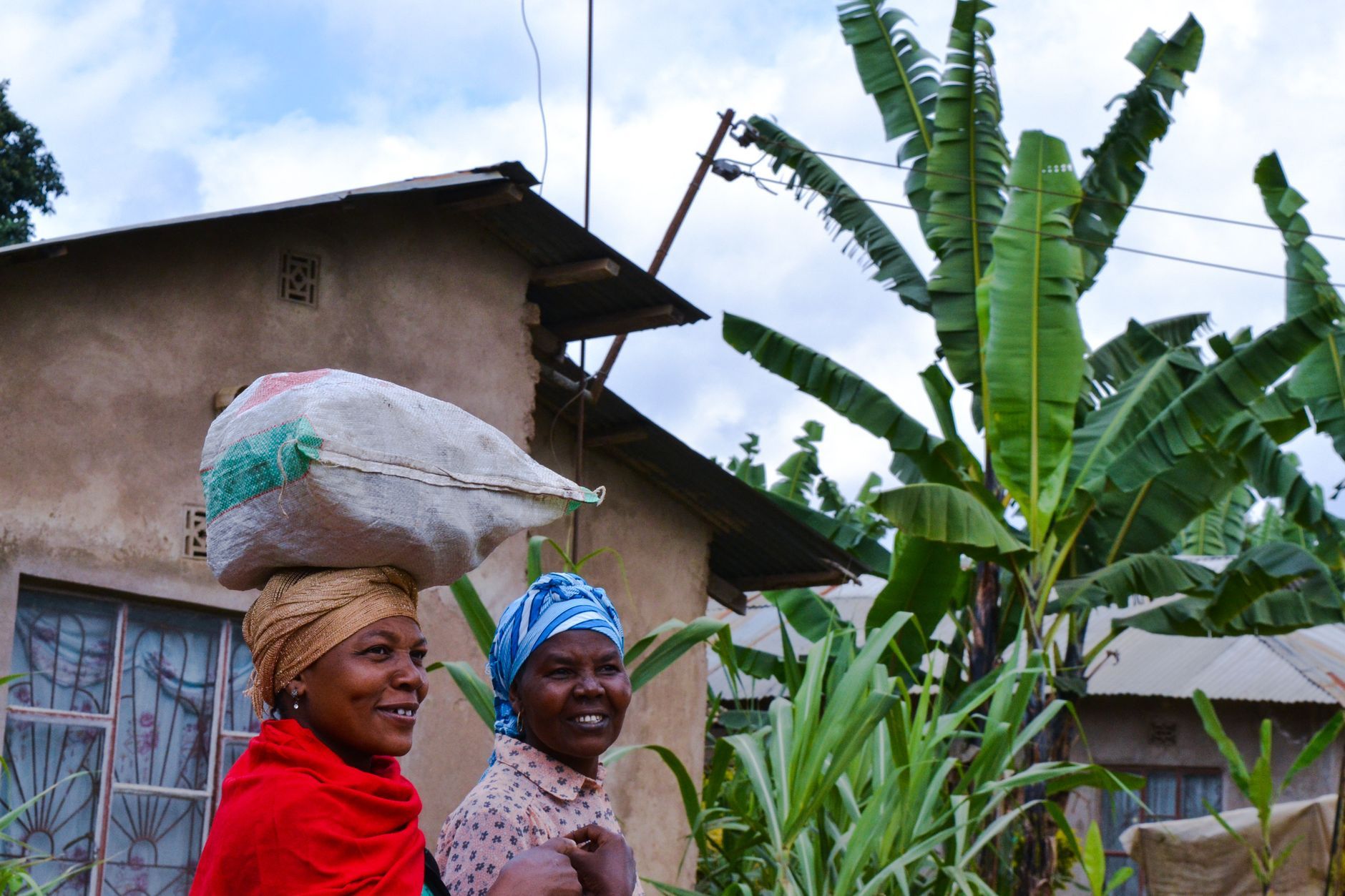 Two smiling Tanzanian women in a village in Arusha