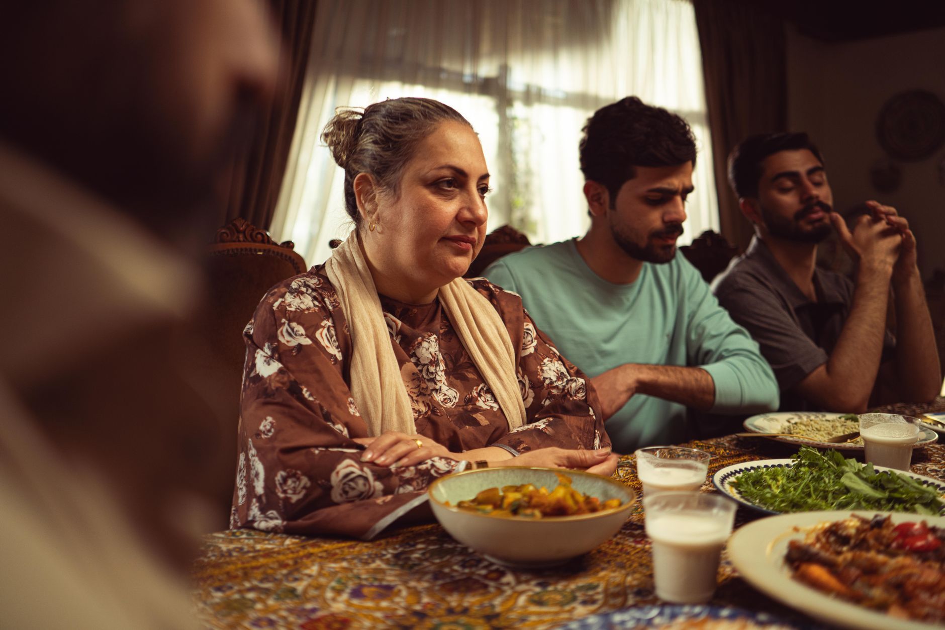 A Pakistani family gathered at a meal