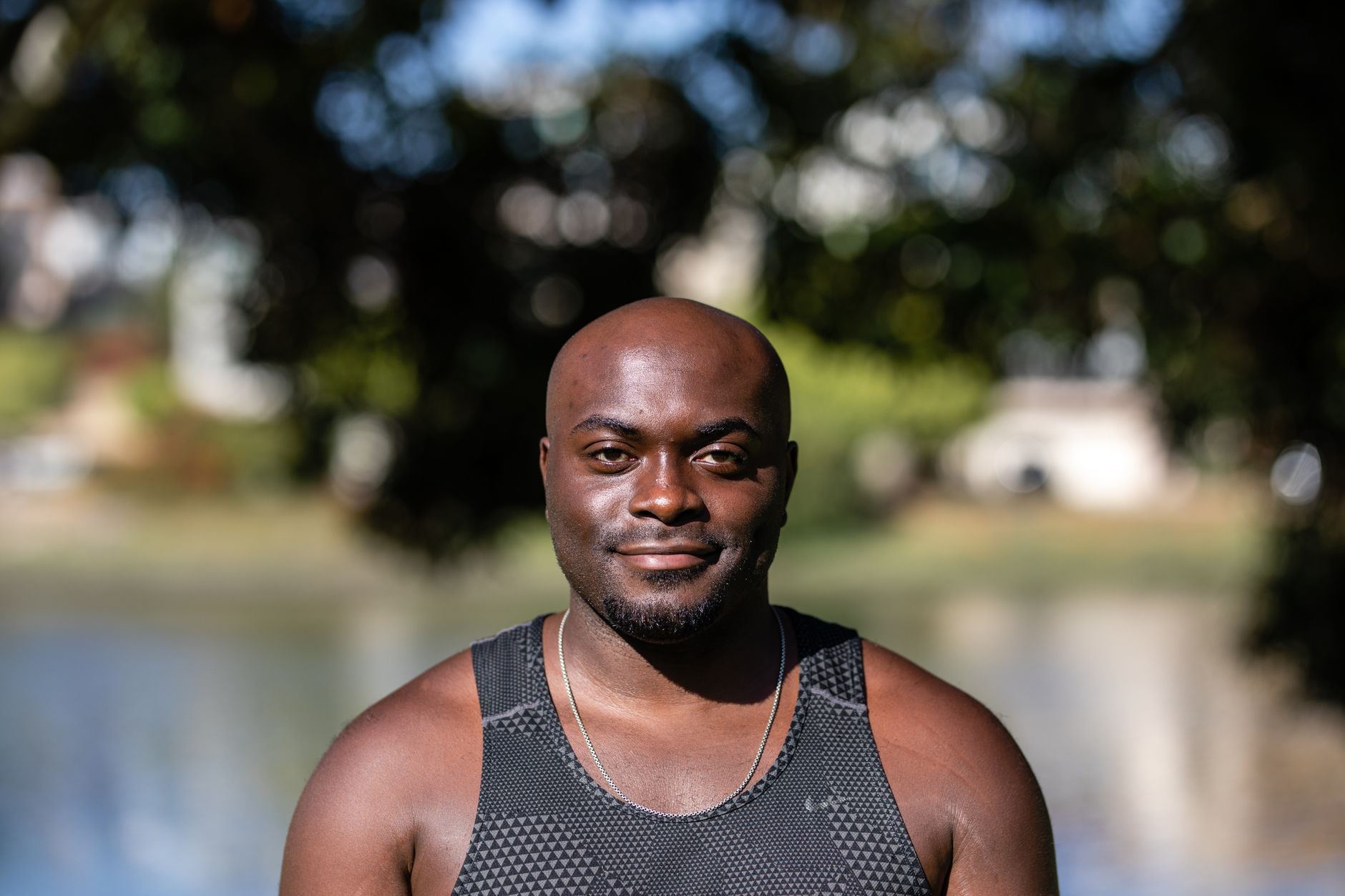 A smiling African American man by a lake