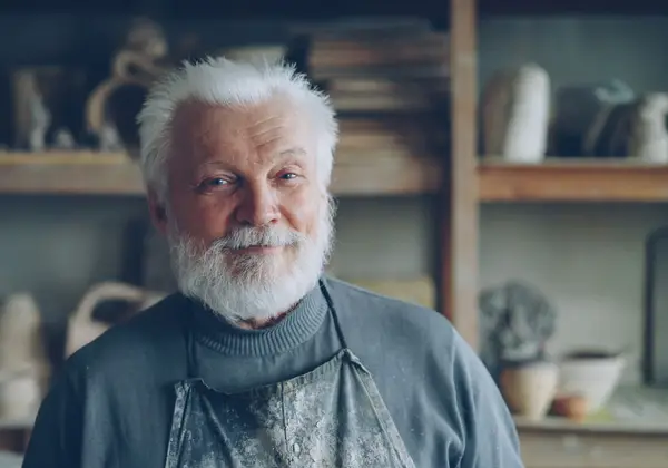 A smiling elderly German craftsman