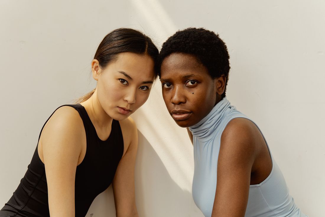 Two women resting forehead to forehead in quiet solidarity
