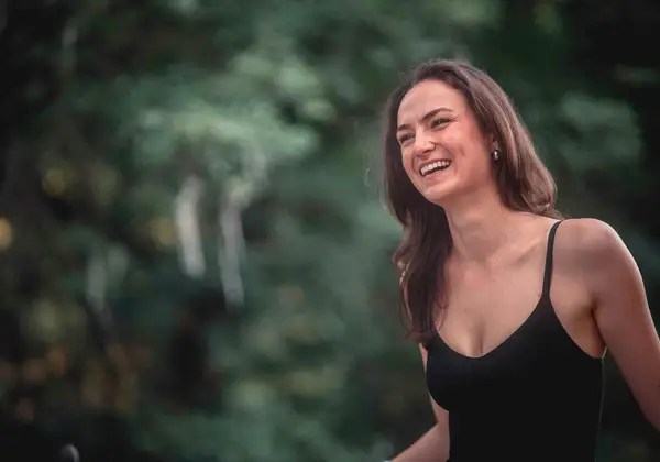 A joyful young German woman laughing