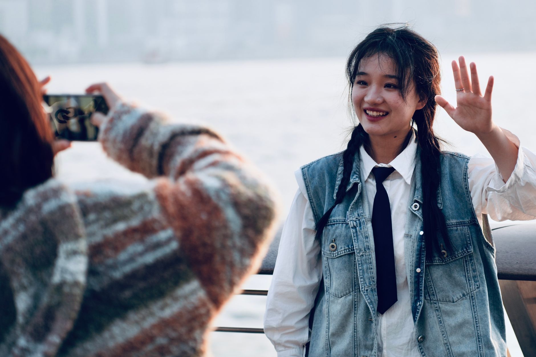 A smiling young woman by Victoria Harbour