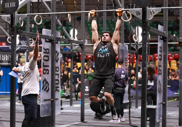An athlete straining through a strength hold in competition