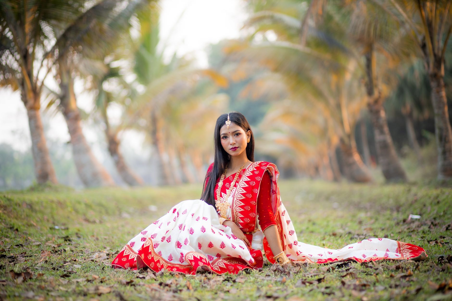 A young Bangladeshi woman in a red and white sari